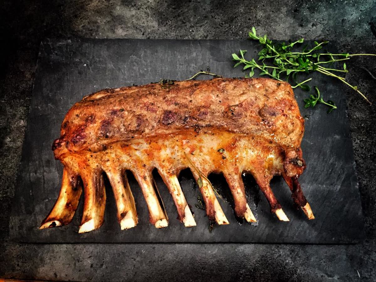 Glazed beef ribs on dark slate with rosemary
